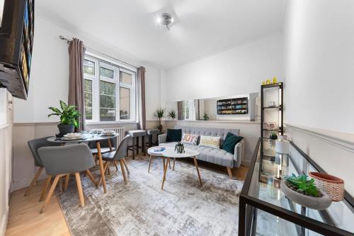 a living room with a couch and a table at Brand New 3 Bedroom flat in Central London in London