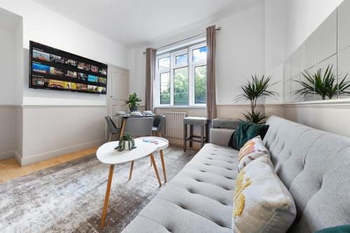 a living room with a couch and a table at Brand New 3 Bedroom flat in Central London in London