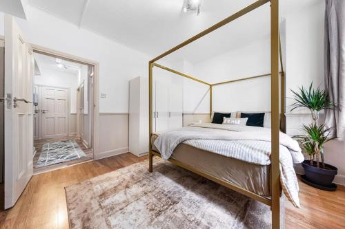 a bedroom with a canopy bed and a mirror at Brand New 3 Bedroom flat in Central London in London