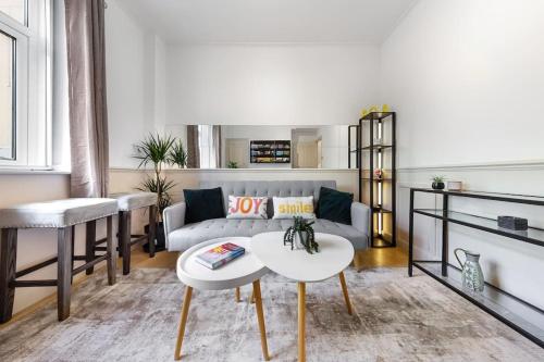 a living room with a couch and a table at Brand New 3 Bedroom flat in Central London in London