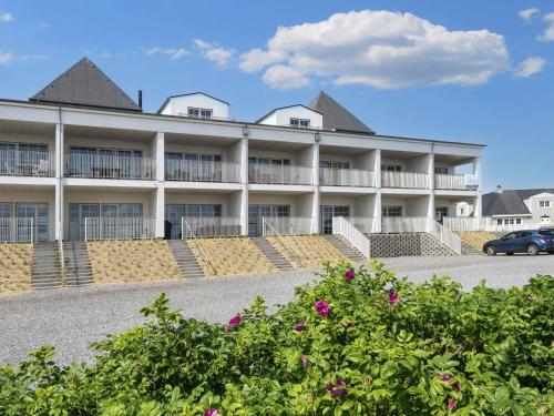 a large white building with a parking lot at 6 person holiday home in Ringkøbing-By Traum in Ringkøbing
