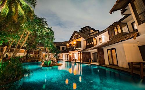 a swimming pool in the courtyard of a villa at Villa Samadhi by Samadhi Age 12 and Above Only in Kuala Lumpur