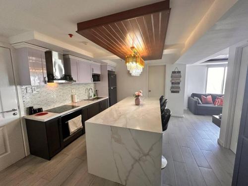 a kitchen with a island in the middle of a room at Analiza Penthouse Azure North in San Fernando