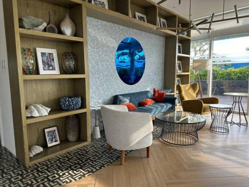 a living room with a blue couch and chairs at Analiza Penthouse Azure North in San Fernando