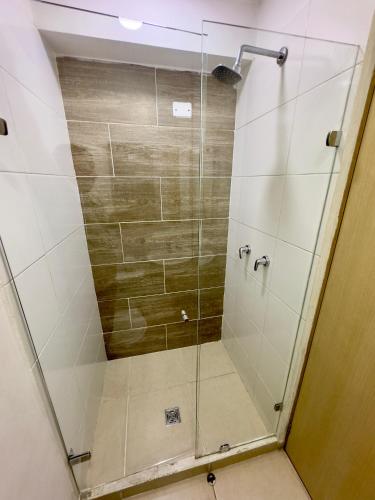 a shower with a glass door in a bathroom at HOTEL MEDELLIN CENTRAL in Medellín