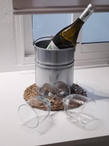a bottle of wine in a bucket with glasses at Poril in Gran Tarajal