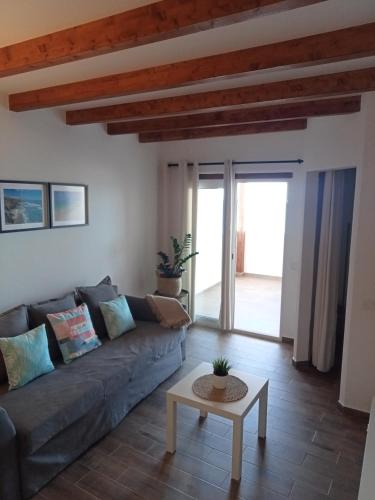 a living room with a couch and a table at Poril in Gran Tarajal