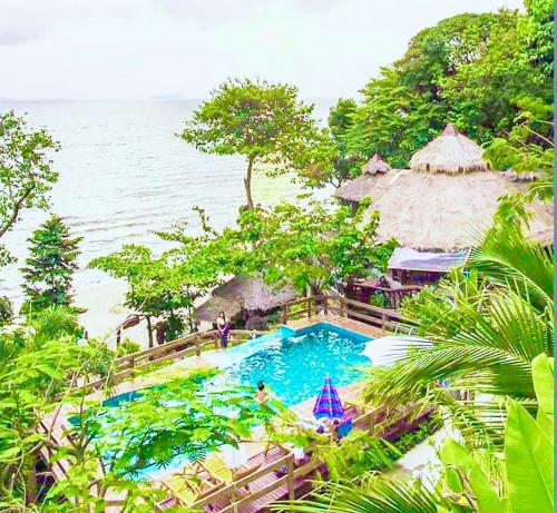 a swimming pool with a view of the ocean at Koh Jum Resort in Ko Jum