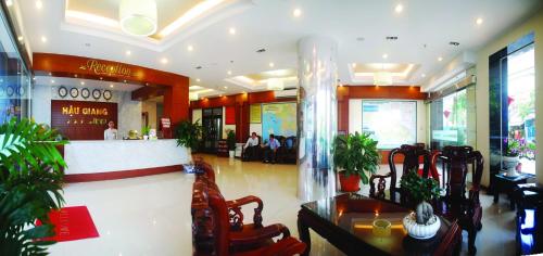a lobby of a restaurant with people sitting at tables at Hau Giang Hotel in Can Tho