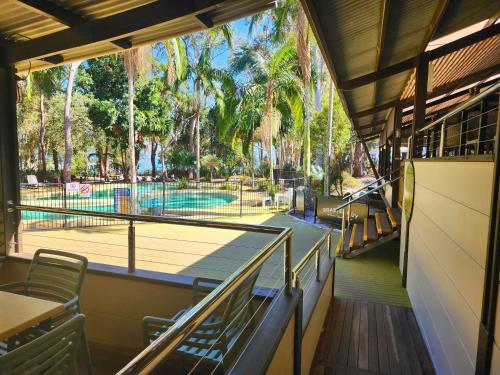 a restaurant with a view of a tennis court at Villa 521 Kingfisher Bay Fraser Island in Kingfisher Bay
