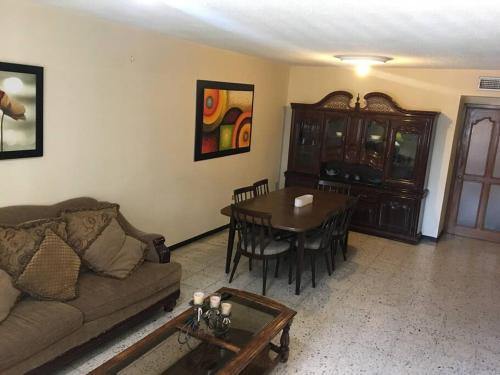 a living room with a couch and a table at Casa muy comoda en excelente lugar in Hermosillo