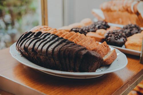 a plate with a large chocolate cake and bread on a table at Uthgra Presidente Perón in Mar del Plata