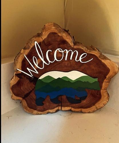 a wooden log with the word elegance written on it at The Great Escape of Arrowhead in Thornhurst