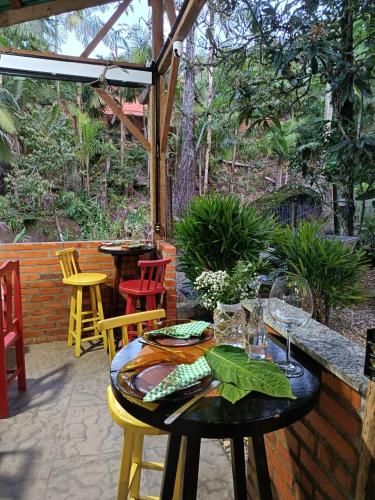 a table with wine glasses on a patio at Chalé Graciosa in Rodeio
