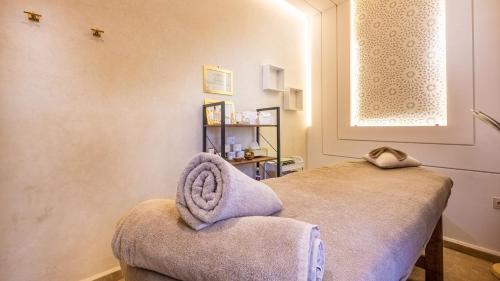 a room with a chair with a towel on it at Riad Luxe Nomade Marrakech & Spa in Marrakech