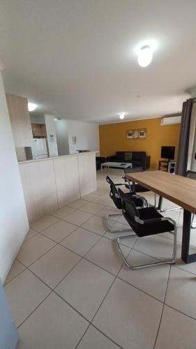 an empty office with a table and black chairs at Blue Waters Apartments in Gold Coast