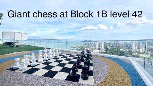a chess board on a ledge with a view of the city at Urban Suites Studio #SelfCheck-In #PrivateSpace in Jelutong
