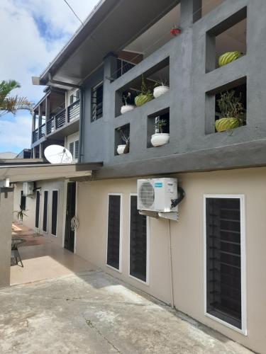a building with plants on the side of it at BIDESI VILLA Apartments in Suva