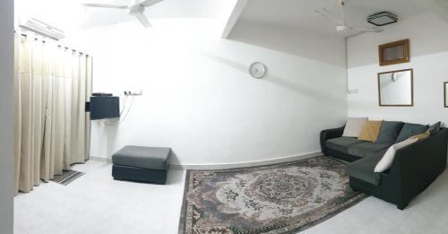 a living room with a couch and a rug at Nuha Kulim Hitech Homestay Islamic in Kulim