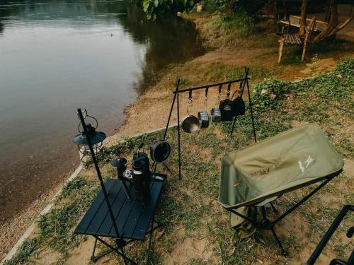 a view of a body of water with some pots and pans at Wangpocamping วังโพแค้มป์ปิ้ง in Ban Wang Pho
