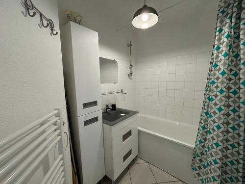 une salle de bain avec un lavabo et une baignoire dans l'établissement Appartement lumineux au port de plaisance des Sables-d'Olonne avec balcon et équipements modernes - FR-1-197-602, à Les Sables-dʼOlonne