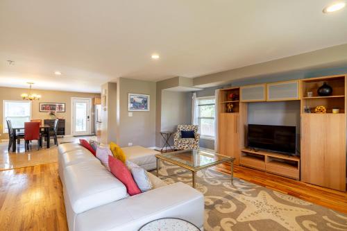 a living room with a white couch and a television at Spacious Row Home next Transit near Downtown w Parking in Chicago