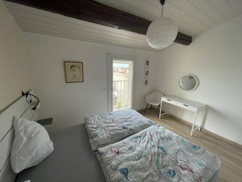 une chambre avec un lit et un bureau dans l'établissement Villa rénovée à 50 m de la plage avec clim et wifi - FR-1-723-162, au Cap d'Agde