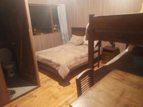 a bedroom with a bunk bed and a mirror at EL TRAPICHE in Sigchos