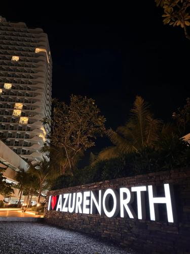a sign on a wall in front of a building at Analiza Penthouse Azure North in San Fernando
