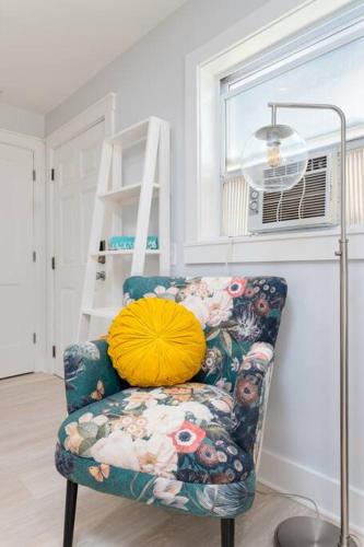 a chair with a pillow on it in a room at Be A Nomad - Jacksonville Beach Studio - 60-Second Walk to Ocean - Sleeps 2 in Jacksonville Beach