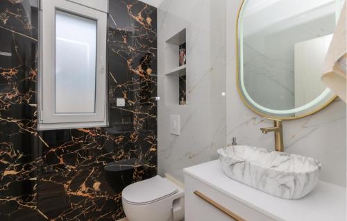 a bathroom with a white toilet and a mirror at Lovely Home In Grubine With Sauna in Grubine