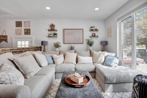 a living room with a couch and a table at Saskatoon 5 bedroom-Big Gatherings-Patio-BBQ-Games Room in Saskatoon