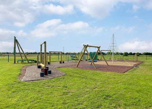 a park with an empty playground with swings at Riverside Holiday Village in Uphill