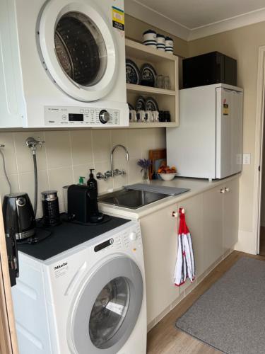 a kitchen with a washing machine and a sink at Waterfront BNB in Gold Coast