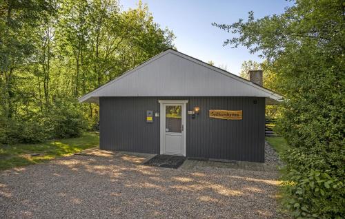 a black garage with a door and a sign on it at Beautiful Home In Toftlund With Wifi in Toftlund