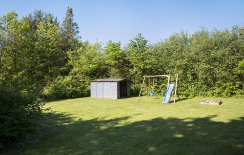 a playground in a field with a swing at Beautiful Home In Toftlund With Wifi in Toftlund