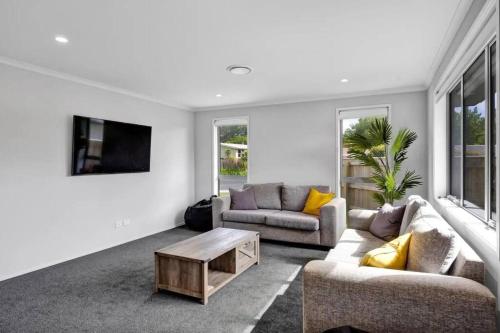 a living room with two couches and a coffee table at Fairbank Avenue in Stratford
