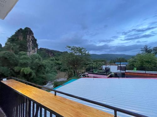 a balcony with a view of a mountain at ภูผา เฮ้าส์ รีสอร์ท in Ban Mung