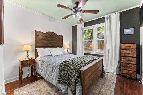 a bedroom with a bed and a ceiling fan at Quiet East Memphis Duplex The Green House in Memphis