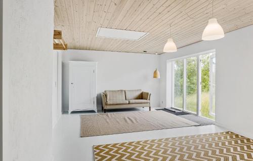 a living room with a chair and a window at Three-Bedroom Holiday Home In Tranekar in Tranekær
