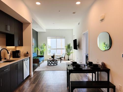 a kitchen and living room with a table and a sink at Modern Hollywood Home Sunset View & Free Parking - 10mins to Universal Studios in Los Angeles