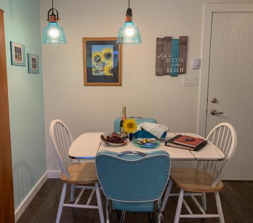 a dining room with a table with chairs and a table and a table at Windslow Guest Suite at Kye Bay in Comox