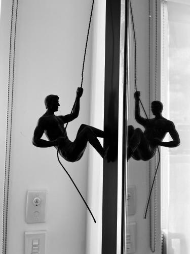 a statue of a man hanging from a window at Matakana Central 981 in Matakana