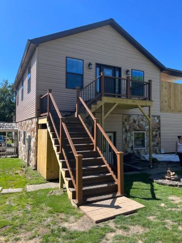 a house with a staircase leading up to a house at Stay, play and relax in Ohiopyle, PA, Hot tub, Pool table, next to the GAP trail in Ohiopyle, PA in Ohiopyle