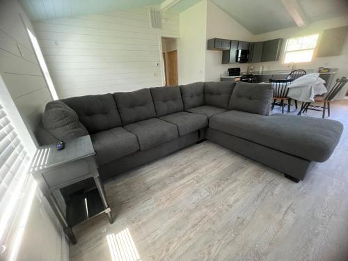 a living room with a couch and a kitchen at Stay, play and relax in Ohiopyle, PA, Hot tub, Pool table, next to the GAP trail in Ohiopyle, PA in Ohiopyle