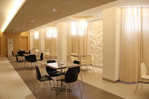 a dining room with tables and chairs in a building at Jinjiang Inn Changsha Railway Station in Changsha