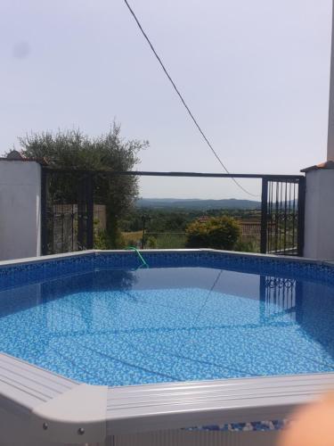 a large swimming pool with blue water in a house at Casa con piscina camino e biliardo in San Giustino Valdarno