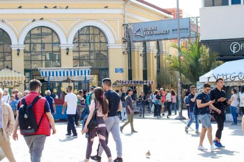 a crowd of people walking on a street in front of a building at Acropolis Ermou Rooms at Plaka in Athens