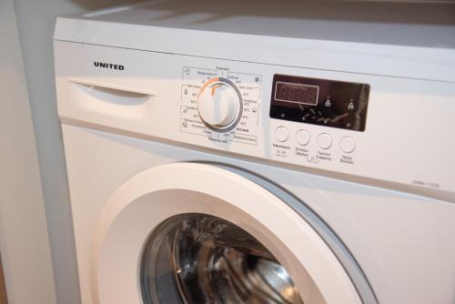 a white washer and dryer in a room at Kaiser Luxury Suites in Achílleion