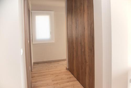 a hallway with a wooden door and a window at Kaiser Luxury Suites in Achílleion